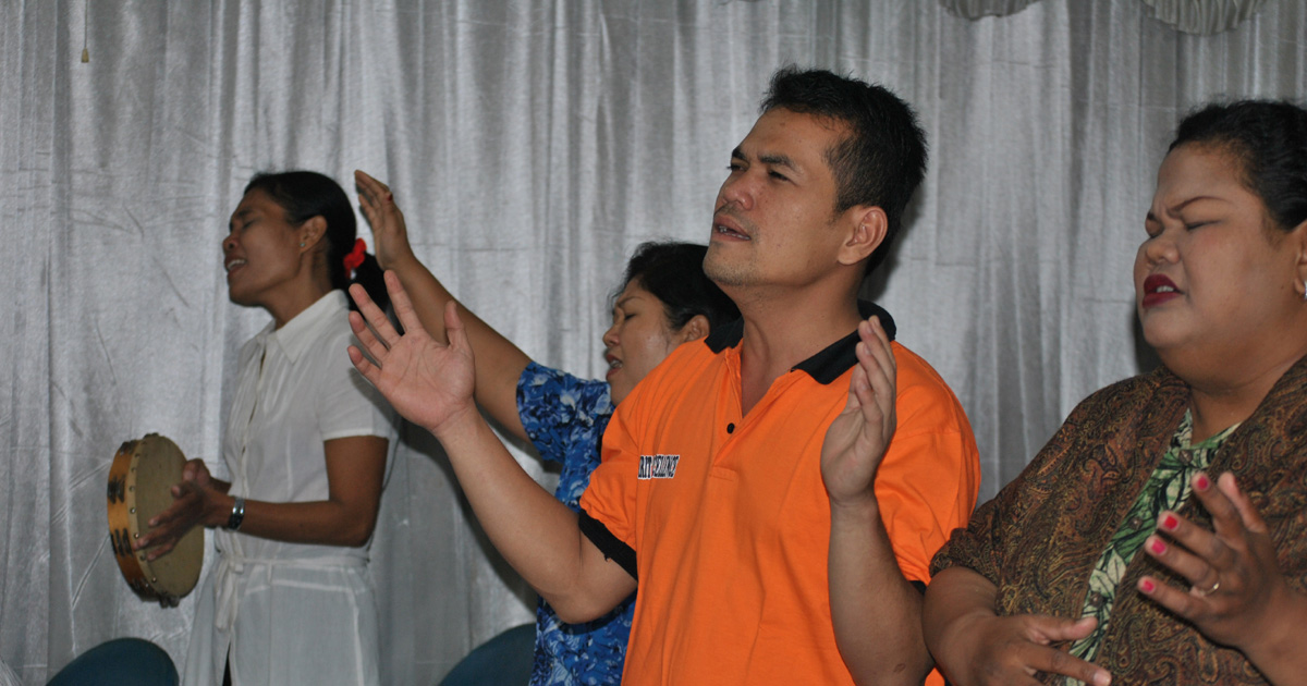 A group of believers is worshipping together.